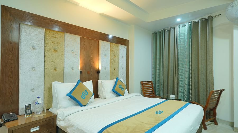 Super deluxe room featuring a king size bed and a window covered with curtains at DLS Hotels The Rock Castle.